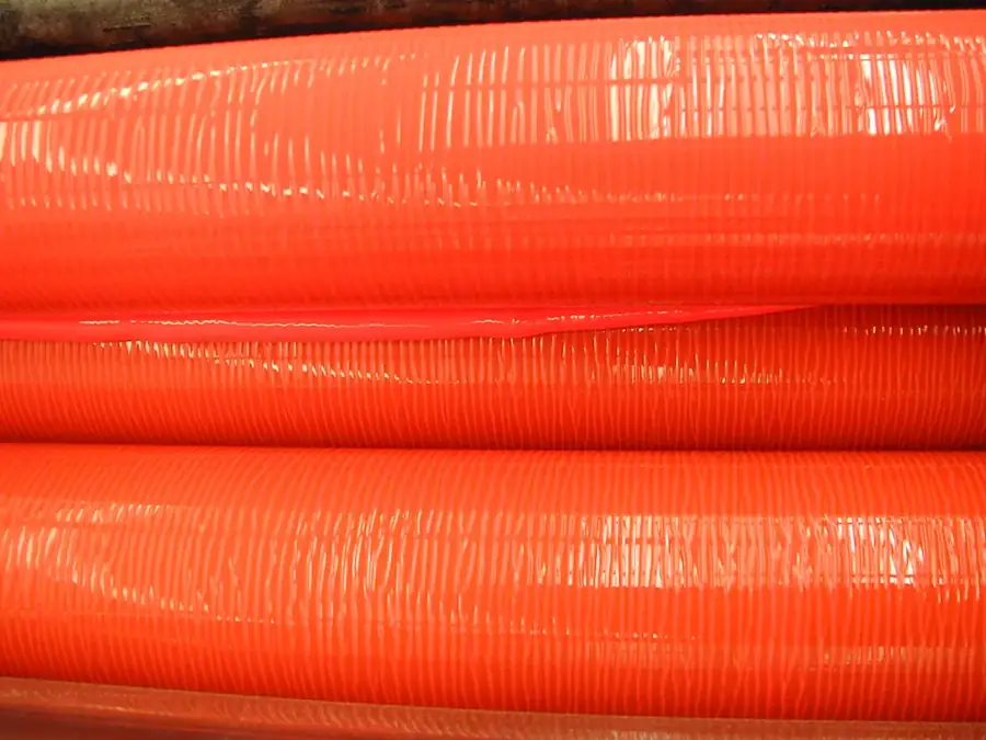 Rubber ink rollers stacked close together, their surfaces catching the light